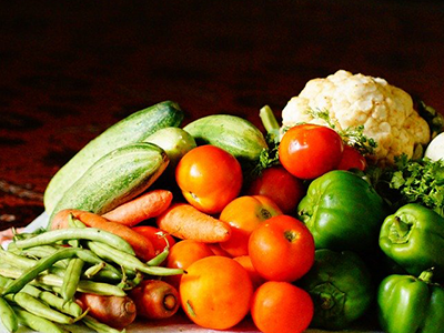 Vegetables in a pile, including; carrots, beans, cauliflower, capsicum and tomatoes